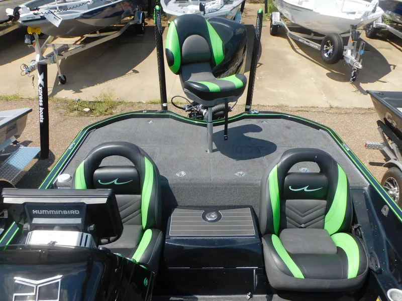 Slide: The Image of 2016 Legend Boats V20 VC with green and black seats in a boatyard. - 15