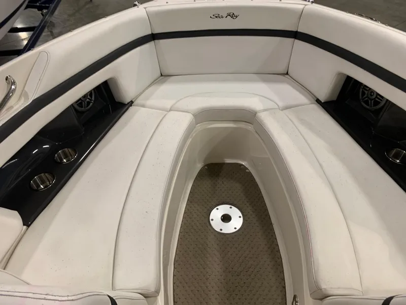 Slide: The Image of 2014 Sea Ray SLX 250 boat interior with white seating and cup holders. - 11
