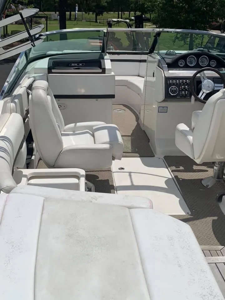 Slide: The Image of 2014 Sea Ray SLX 250 boat interior with white seating and modern dashboard. - 4