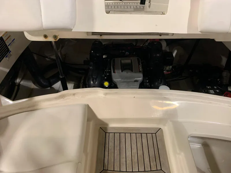 Slide: The Image of 2014 Sea Ray SLX 250 boat engine compartment with seating and deck view. - 8