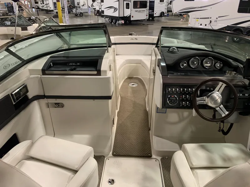 Slide: The Image of 2014 Sea Ray SLX 250 boat interior with steering wheel and dashboard. - 9