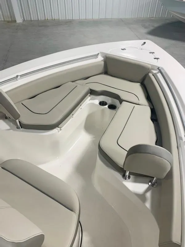 Slide: The Image of 2024 Key West 219 FS boat interior with cushioned seating and cup holders. - 10