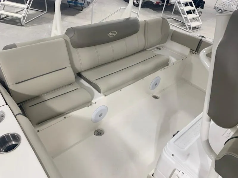 Slide: The Image of 2024 Key West 219 FS boat interior with beige seating and cup holders. - 7