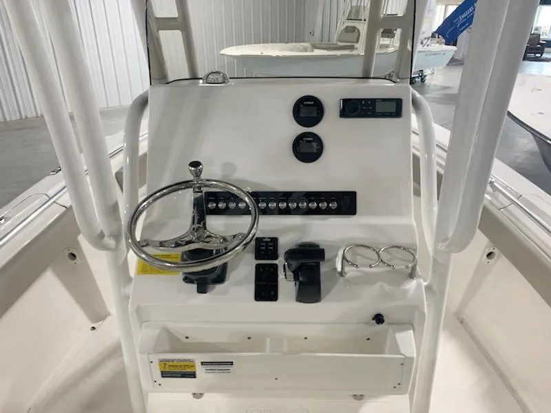 Slide: The Image of 2024 Key West 219 FS boat console with steering wheel and controls. - 6