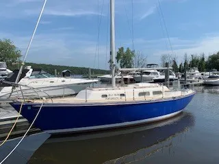 Slide: The Image of 1970 Pearson 35 Sloop sailboat docked at a marina on a sunny day. - 10