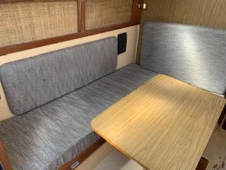 Slide: The Image of Interior seating area of a 1970 Pearson 35 Sloop sailboat with a wooden table. - 13