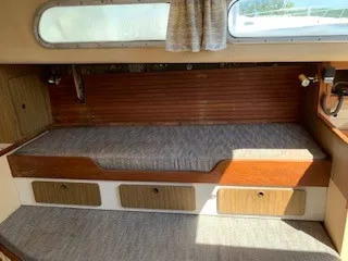 Slide: The Image of 1970 Pearson 35 Sloop interior cabin with wooden accents and storage drawers. - 15