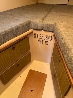 Slide: The Image of Interior cabin of 1970 Pearson 35 Sloop with storage drawers and cushioned seating. - 23