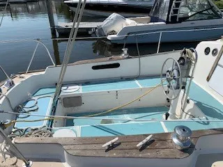 Slide: The Image of 1970 Pearson 35 Sloop sailboat cockpit with steering wheel and marina background. - 4