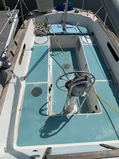 Slide: The Image of 1970 Pearson 35 Sloop sailboat cockpit with blue deck and steering wheel. - 5