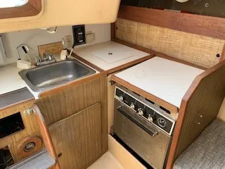 Slide: The Image of 1970 Pearson 35 Sloop galley with sink, stove, and storage. - 9