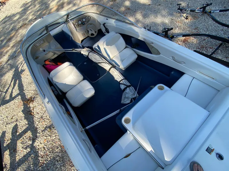 Slide: The Image of 2001 Bayliner 215 Bowrider boat interior with white seating and control panel. - 15