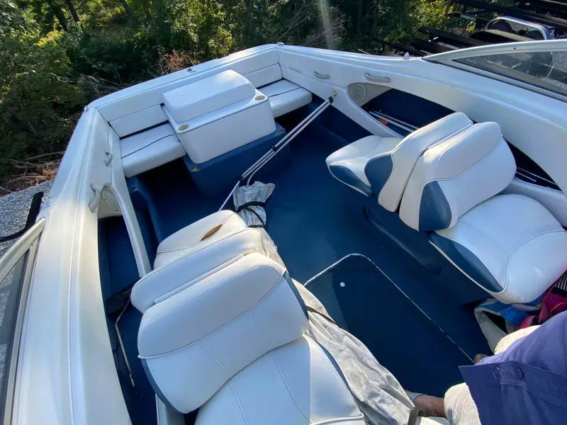 Slide: The Image of 2001 Bayliner 215 Bowrider interior with white and blue seating. - 2