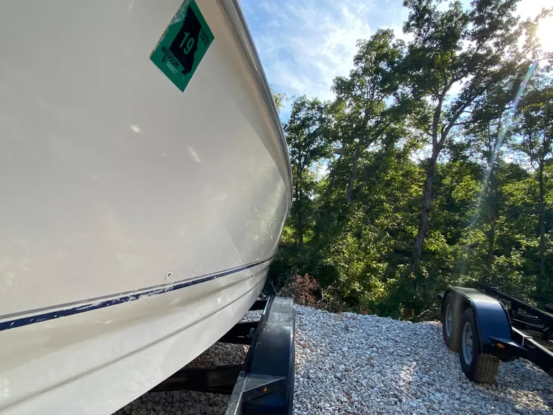 Slide: The Image of 2001 Bayliner 215 Bowrider boat on trailer, side view, outdoors. - 23