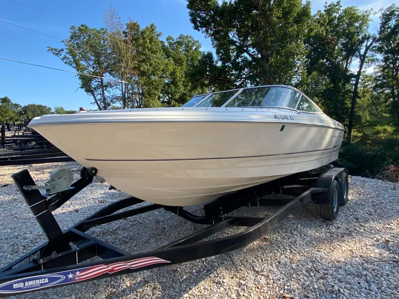 Slide: The Image of 2001 Bayliner 215 Bowrider boat on a trailer, parked outdoors. - 25