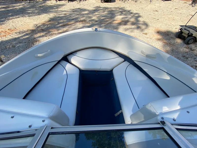 Slide: The Image of 2001 Bayliner 215 Bowrider boat interior with white seating and blue accents. - 7