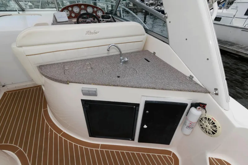 Slide: The Image of 2005 Rinker Fiesta Vee 342 boat interior with sink and storage compartments. - 10
