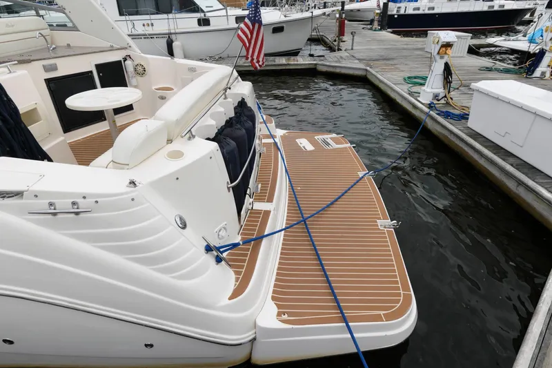 Slide: The Image of 2005 Rinker Fiesta Vee 342 docked, showing swim platform and stern area. - 11