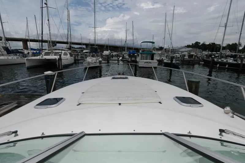Slide: The Image of 2005 Rinker Fiesta Vee 342 docked at a marina with other boats. - 12