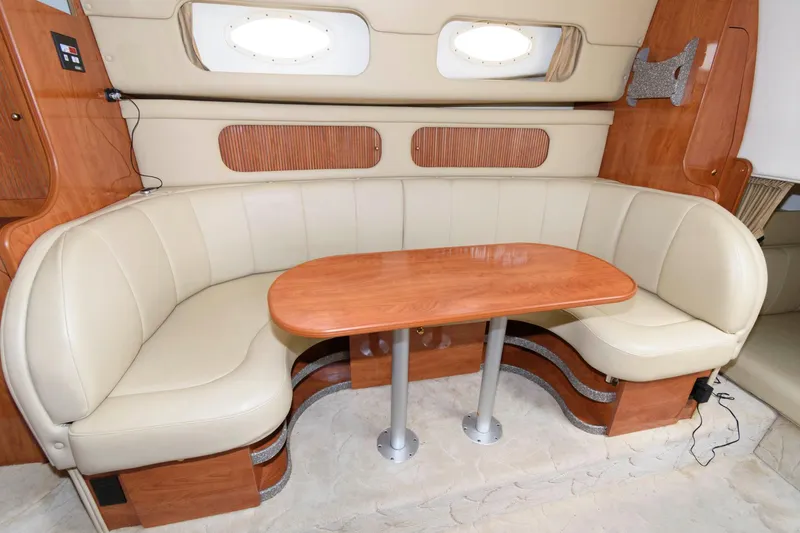 Slide: The Image of 2005 Rinker Fiesta Vee 342 interior, beige leather seating with wooden table. - 17