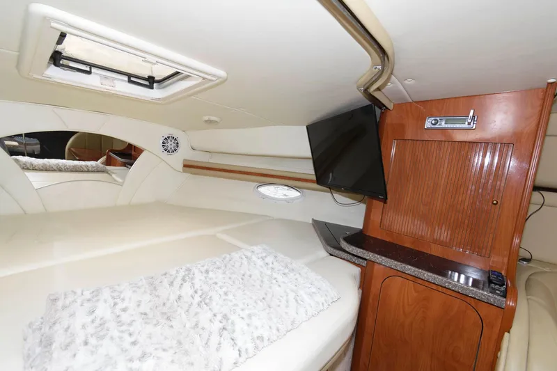 Slide: The Image of Interior cabin of a 2005 Rinker Fiesta Vee 342 with TV and wooden cabinetry. - 20