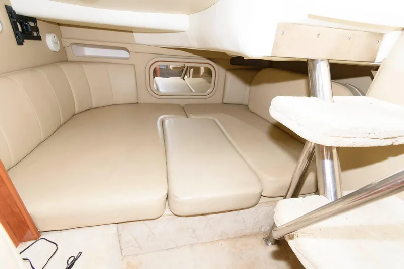 Slide: The Image of 2005 Rinker Fiesta Vee 342 cabin interior with beige seating and steps. - 21