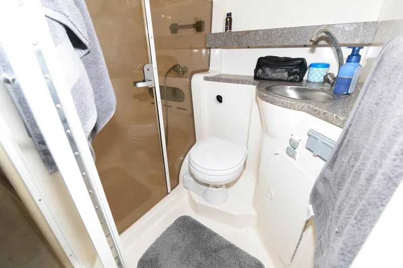 Slide: The Image of 2005 Rinker Fiesta Vee 342 bathroom with shower, toilet, sink, and storage. - 22