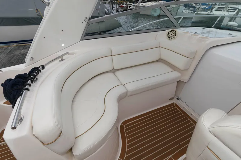 Slide: The Image of 2005 Rinker Fiesta Vee 342 boat interior with white leather seating and wood flooring. - 6