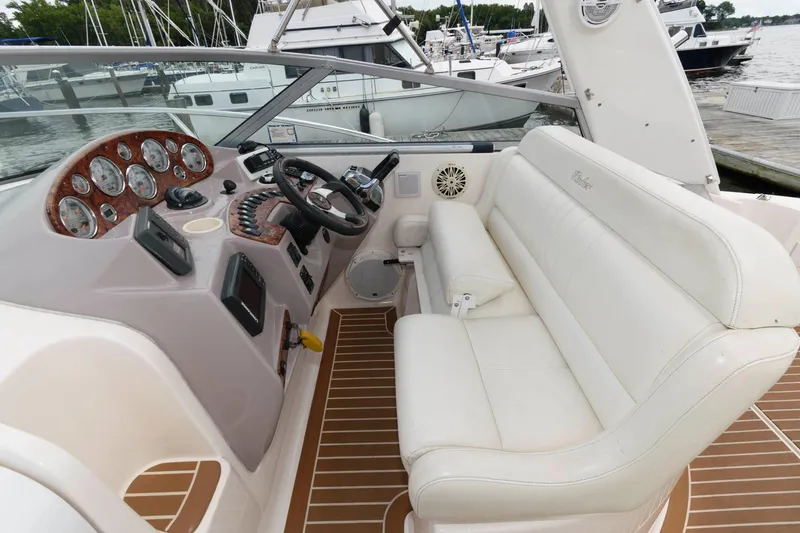 Slide: The Image of 2005 Rinker Fiesta Vee 342 boat cockpit with white seating and control panel. - 7