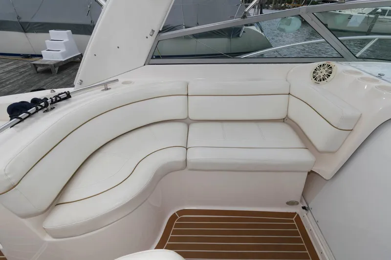 Slide: The Image of 2005 Rinker Fiesta Vee 342 boat with white leather seating and wooden flooring. - 9