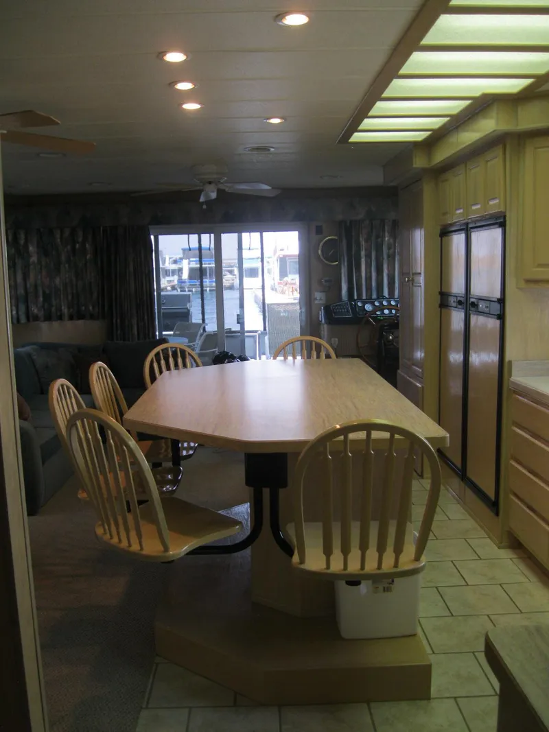 Slide: The Image of Spacious kitchen with wooden dining table and chairs, featuring modern appliances, Horizon model 2000. - 8