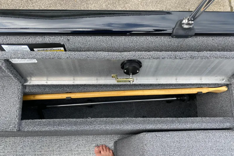 Slide: The Image of 2020 Tracker Pro Guide V175 storage compartment with fishing rod. - 14