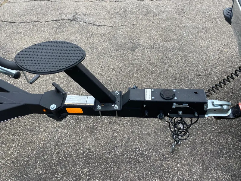 Slide: The Image of 2020 Tracker Pro Guide V175 boat trailer hitch and stand on asphalt. - 19