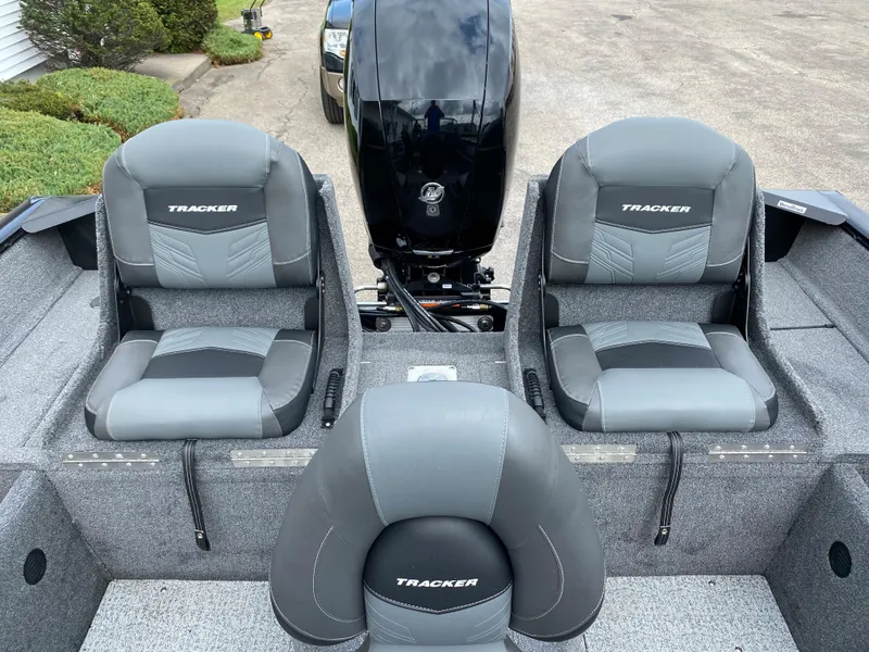 Slide: The Image of 2020 Tracker Pro Guide V175 boat interior with three seats and outboard motor. - 7