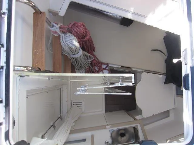 Slide: The Image of Interior view of 2025 Jeanneau Yacht 65 showing ropes and compact kitchen area. - 24