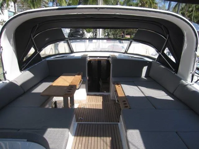 Slide: The Image of 2025 Jeanneau Yacht 65 interior with spacious seating and wooden tables. - 40