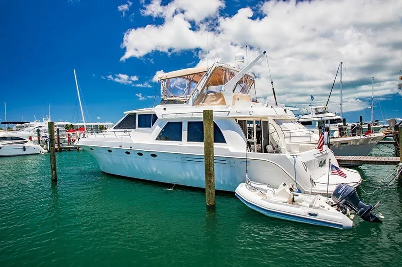 The Image of Luxury Navigator 5800 yacht docked in marina, clear blue sky, 1999 model. - 0