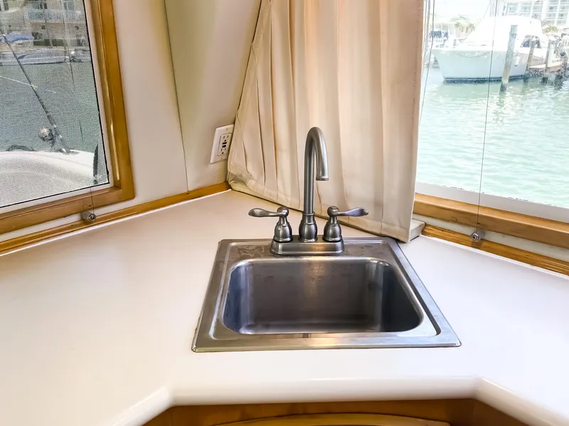 Slide: The Image of 1999 Navigator 5800 yacht kitchen sink with window view of marina. - 10
