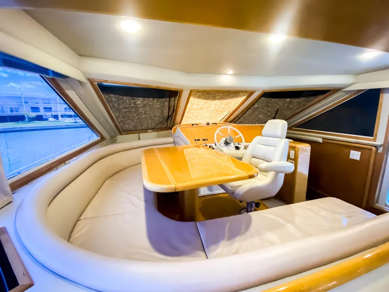 Slide: The Image of Luxurious interior of a 1999 Navigator 5800 yacht with plush seating and helm. - 12