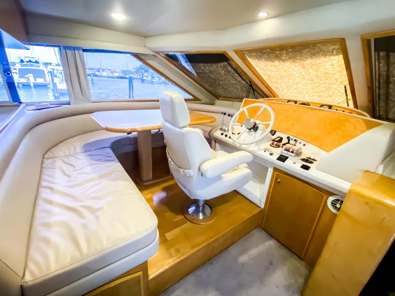 Slide: The Image of Luxurious 1999 Navigator 5800 yacht interior with helm, seating, and panoramic windows. - 13