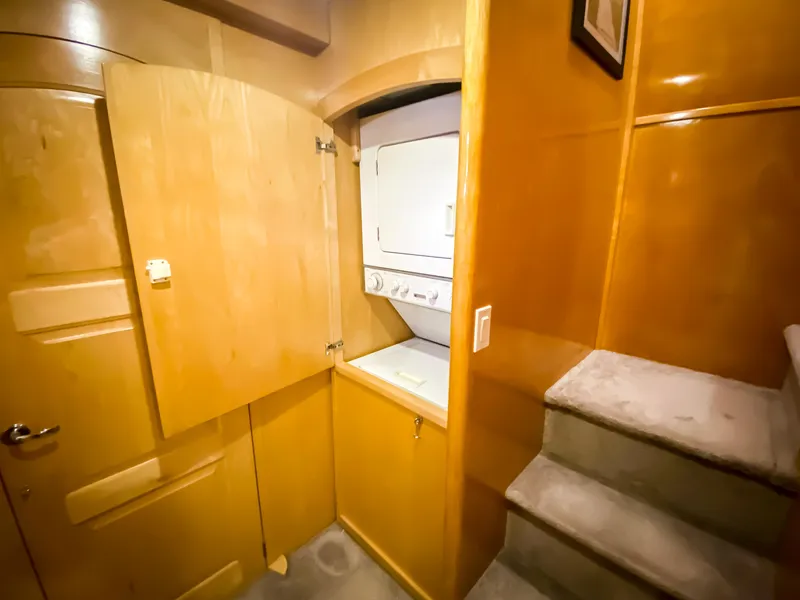Slide: The Image of Laundry area with stacked washer and dryer in 1999 Navigator 5800 yacht. - 17