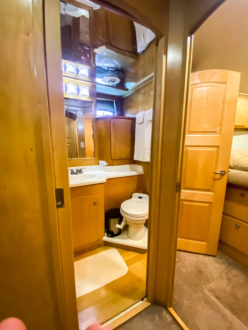 Slide: The Image of Compact bathroom in a 1999 Navigator 5800 yacht with wooden cabinetry and modern fixtures. - 19