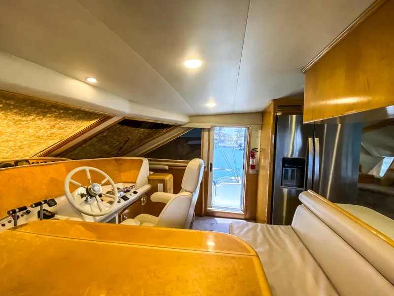 Slide: The Image of Interior of 1999 Navigator 5800 yacht with helm, seating, and modern appliances. - 28