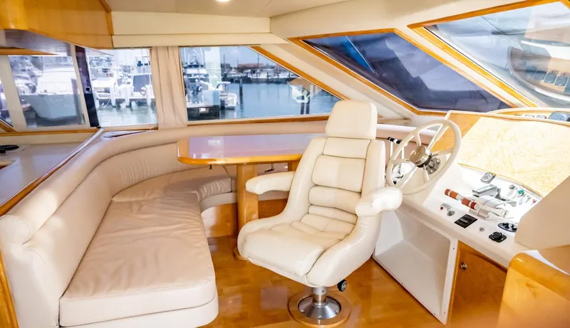 Slide: The Image of Luxurious interior of a 1999 Navigator 5800 yacht with leather seating and helm. - 29