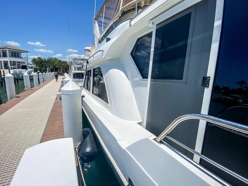 Slide: The Image of 1999 Navigator 5800 yacht docked at marina under clear blue sky. - 3