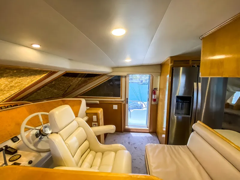 Slide: The Image of Luxurious interior of 1999 Navigator 5800 yacht with leather seating and modern appliances. - 30