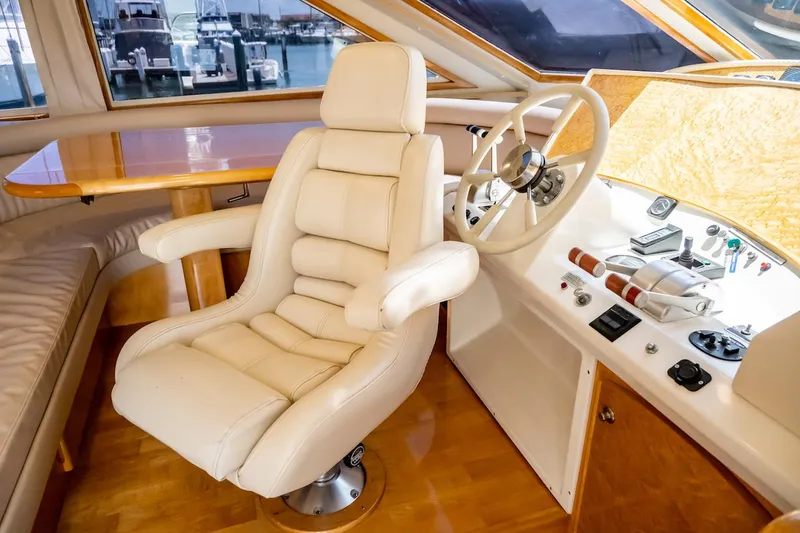 Slide: The Image of Luxurious interior of a 1999 Navigator 5800 yacht with plush captain's chair and control panel. - 31