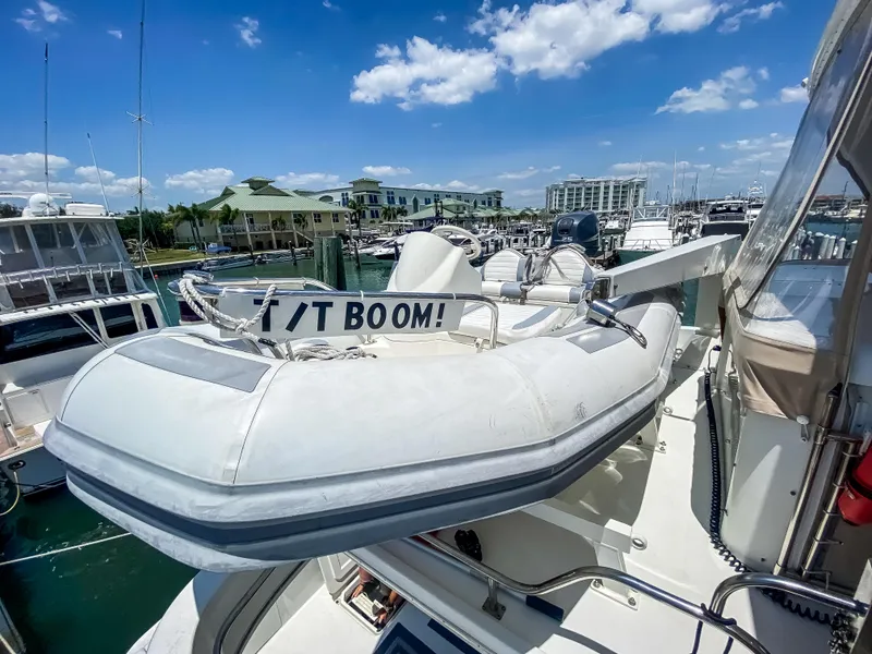 Slide: The Image of Inflatable boat on Navigator 5800 yacht, docked at marina under blue sky. - 35