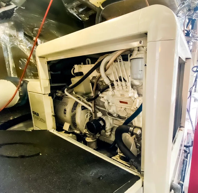Slide: The Image of Engine compartment of a 1999 Navigator 5800 yacht, showcasing mechanical components and wiring. - 37