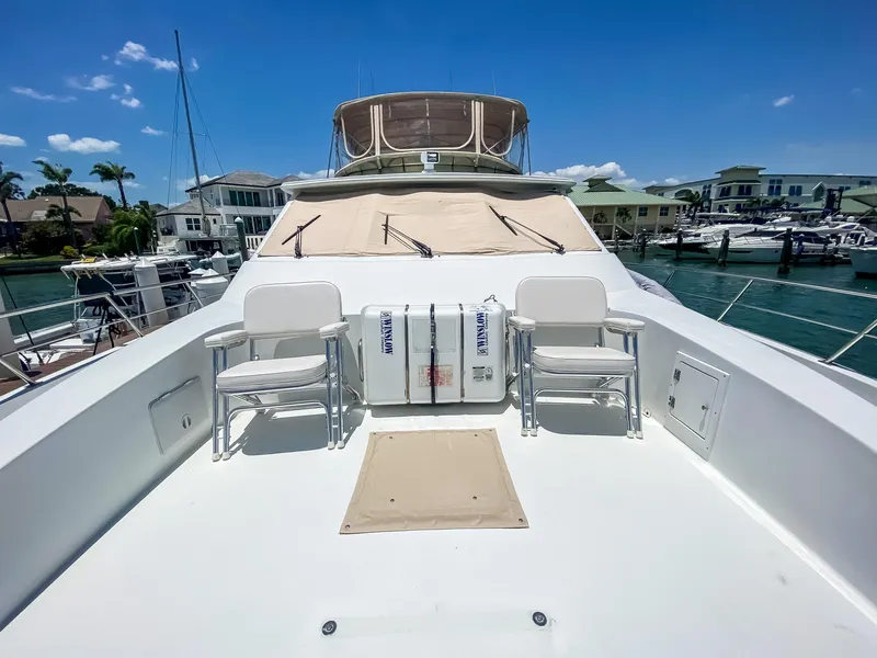 Slide: The Image of 1999 Navigator 5800 yacht deck with chairs, marina view, clear blue sky. - 4